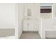Bathroom featuring a vanity, soaking tub, and window at 37154 W La Paz St, Maricopa, AZ 85138