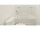 A clean bathroom with a neutral aesthetic features a bathtub and toilet at 37154 W La Paz St, Maricopa, AZ 85138