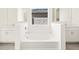 Bright bathroom featuring a modern soaking tub with dual vanities on either side at 37154 W La Paz St, Maricopa, AZ 85138
