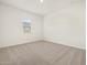 Bright bedroom with neutral carpet and window at 37154 W La Paz St, Maricopa, AZ 85138