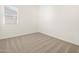 Comfortable bedroom featuring soft carpeting and a window allowing in natural light at 37154 W La Paz St, Maricopa, AZ 85138