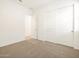 Well-lit bedroom with carpeting, a closet, and ample space for furnishings at 37154 W La Paz St, Maricopa, AZ 85138