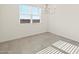 Dining area with large window, modern light fixture, and tile flooring at 37154 W La Paz St, Maricopa, AZ 85138