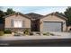 Charming single-story home featuring stone accents, a gray garage door, and low-maintenance desert landscaping at 37154 W La Paz St, Maricopa, AZ 85138