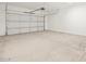 Spacious two car garage featuring a clean slab floor at 37154 W La Paz St, Maricopa, AZ 85138