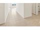 Neutral tile flooring runs throughout the hallway, providing a clean and modern aesthetic at 37154 W La Paz St, Maricopa, AZ 85138