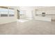 Bright, open living area showcasing tile floors, kitchen, and a sliding glass door at 37154 W La Paz St, Maricopa, AZ 85138