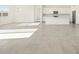 Bright, open-concept living area features tile flooring, lots of natural light, and a view into the modern kitchen at 37154 W La Paz St, Maricopa, AZ 85138