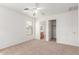 Neutral carpeted bedroom with ceiling fan, and closet and bathroom access at 3728 W Fremont Rd, Phoenix, AZ 85041