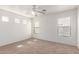 Well-lit bedroom with neutral carpeting and a ceiling fan at 3728 W Fremont Rd, Phoenix, AZ 85041