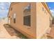 Side exterior view of the house, showcasing stucco siding and several windows at 3728 W Fremont Rd, Phoenix, AZ 85041