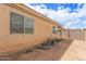 Exterior view of the home showing a low-maintenance yard and a block wall fence at 3728 W Fremont Rd, Phoenix, AZ 85041
