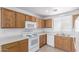 Functional kitchen with ample cabinet space, white appliances, and tile floors for easy maintenance at 3728 W Fremont Rd, Phoenix, AZ 85041
