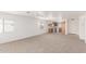 Bright, open living area with connecting kitchen, carpet floors, and ample natural light at 3728 W Fremont Rd, Phoenix, AZ 85041