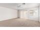 Spacious living room with carpet flooring, natural light, and access to the patio at 3728 W Fremont Rd, Phoenix, AZ 85041