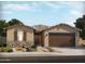 Charming single-story home featuring stone accents, a two-car garage, and a well-manicured front yard with desert landscaping at 37372 W San Sisto Ave, Maricopa, AZ 85138
