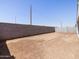 Empty backyard with cinder block fence at 37385 W San Sisto Ave, Maricopa, AZ 85138