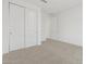 Bright bedroom featuring neutral carpet and large sliding closet doors at 37385 W San Sisto Ave, Maricopa, AZ 85138