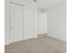 Bright bedroom featuring neutral carpet and closet with sliding doors at 37385 W San Sisto Ave, Maricopa, AZ 85138