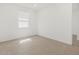 Bright bedroom featuring wood-look flooring and a large window for natural light at 37385 W San Sisto Ave, Maricopa, AZ 85138