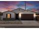Charming single-story home featuring neutral stucco, a tile roof and a two-car garage at 37385 W San Sisto Ave, Maricopa, AZ 85138
