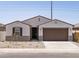 Charming single-story home featuring neutral stucco, a tile roof and a two-car garage at 37385 W San Sisto Ave, Maricopa, AZ 85138