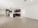Modern kitchen featuring stainless steel appliances, granite countertops, and wood-look tile flooring at 37385 W San Sisto Ave, Maricopa, AZ 85138