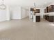 Open-concept kitchen with modern stainless steel appliances, island, and wood-look tile flooring at 37385 W San Sisto Ave, Maricopa, AZ 85138