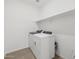 Modern laundry room featuring a newer washer and dryer, plus shelving for storage at 37385 W San Sisto Ave, Maricopa, AZ 85138