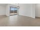 Bright living room with a sliding glass doors leading to back patio and wood-look tile flooring at 37385 W San Sisto Ave, Maricopa, AZ 85138