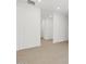 Bright living space featuring wood-look flooring and large windows for natural light at 37385 W San Sisto Ave, Maricopa, AZ 85138