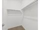Clean, simple walk-in closet with carpet and ample storage space at 37385 W San Sisto Ave, Maricopa, AZ 85138