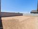 Spacious dirt backyard enclosed by block wall fencing at 37399 W San Sisto Ave, Maricopa, AZ 85138