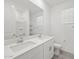 Bathroom featuring a double sink vanity, mirror, and walk in shower at 37399 W San Sisto Ave, Maricopa, AZ 85138