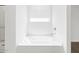 Bathroom with a window above a soaking tub and shower, offering a relaxing space at 37399 W San Sisto Ave, Maricopa, AZ 85138