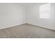 Bedroom featuring neutral carpet, white walls, and window with blinds at 37399 W San Sisto Ave, Maricopa, AZ 85138