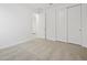 Bedroom featuring neutral carpet, white walls, doors and trim at 37399 W San Sisto Ave, Maricopa, AZ 85138