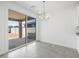 Dining area with chandelier, tile flooring and sliding glass doors to the patio at 37399 W San Sisto Ave, Maricopa, AZ 85138