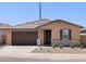 Charming single-story home with a two-car garage, stone accents, neutral paint, and a well-maintained front yard at 37399 W San Sisto Ave, Maricopa, AZ 85138