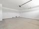 Spacious two car garage with painted walls and concrete flooring offering plenty of room for storage at 37399 W San Sisto Ave, Maricopa, AZ 85138