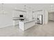 Spacious kitchen featuring granite countertops, white cabinetry, and stainless steel appliances at 37399 W San Sisto Ave, Maricopa, AZ 85138
