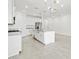 Open kitchen featuring a large island, white cabinetry, and stainless steel appliances at 37399 W San Sisto Ave, Maricopa, AZ 85138