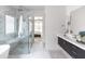 Bright bathroom with walk-in shower, modern vanity and a glimpse into the bedroom at 3927 E Sheila Ln, Phoenix, AZ 85018