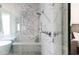 Bright bathroom features a glass shower, seating, marble accents and modern fixtures at 3927 E Sheila Ln, Phoenix, AZ 85018