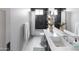 Stylish bathroom with modern vanity, black subway tile accent wall, and well-lit mirror at 3927 E Sheila Ln, Phoenix, AZ 85018