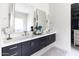Contemporary bathroom showcasing dual vanities, sleek mirrors, modern fixtures, and stylish cabinetry at 3927 E Sheila Ln, Phoenix, AZ 85018