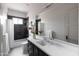 Stylish bathroom with modern vanity, black subway tile accent wall, and well-lit mirror at 3927 E Sheila Ln, Phoenix, AZ 85018