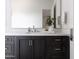 Elegant bathroom features a dark vanity, large mirror, and ample counter space at 3927 E Sheila Ln, Phoenix, AZ 85018