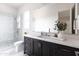 Modern bathroom boasts a glass-enclosed shower and a sleek vanity with a large mirror at 3927 E Sheila Ln, Phoenix, AZ 85018