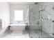 Elegant bathroom featuring a freestanding tub, a spacious walk-in shower and marble tile walls at 3927 E Sheila Ln, Phoenix, AZ 85018
